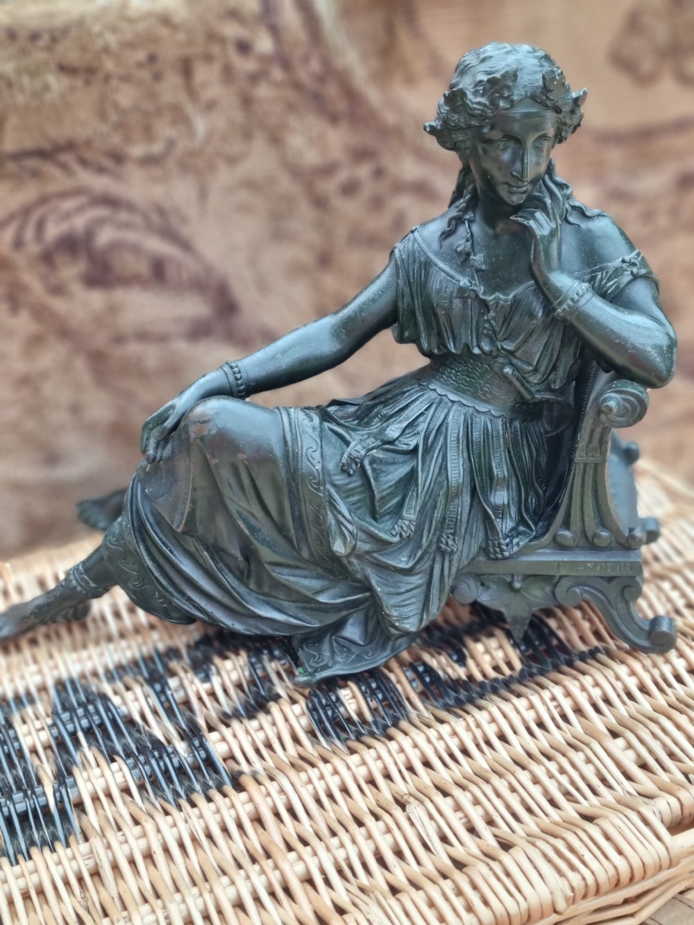 A 19th-century dark green patinated bronze figure depicting a seated classical woman in draped clothing resting her chin on her hand. View VIII