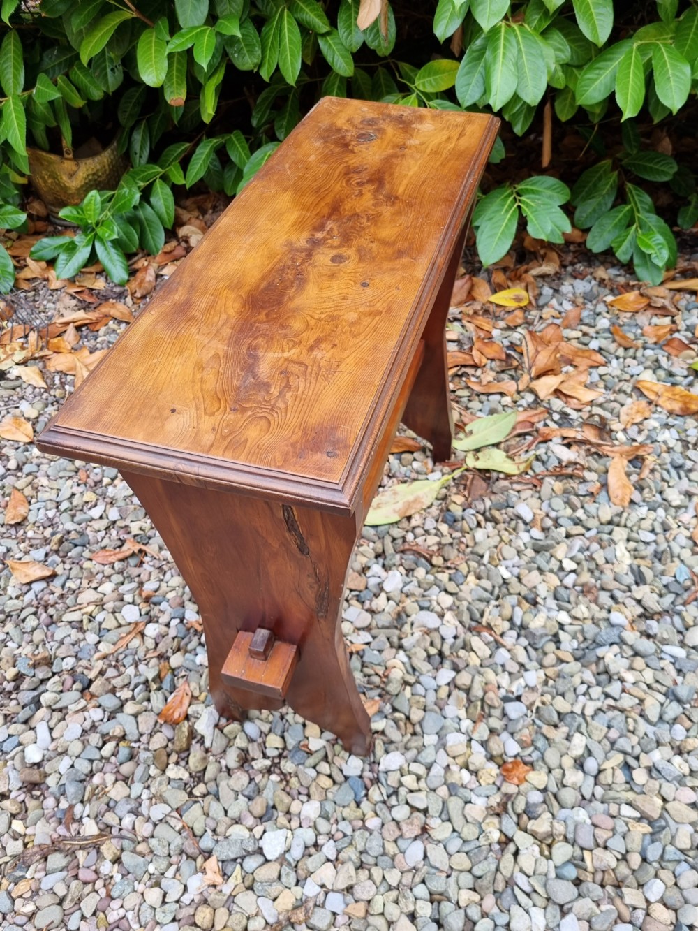 A rectangular solid yew wood stool with a lower shelf, moulded top edge, and slab-side legs. View II
