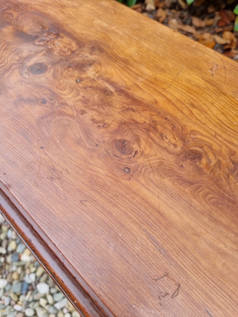 A rectangular solid yew wood stool with a lower shelf, moulded top edge, and slab-side legs. View III