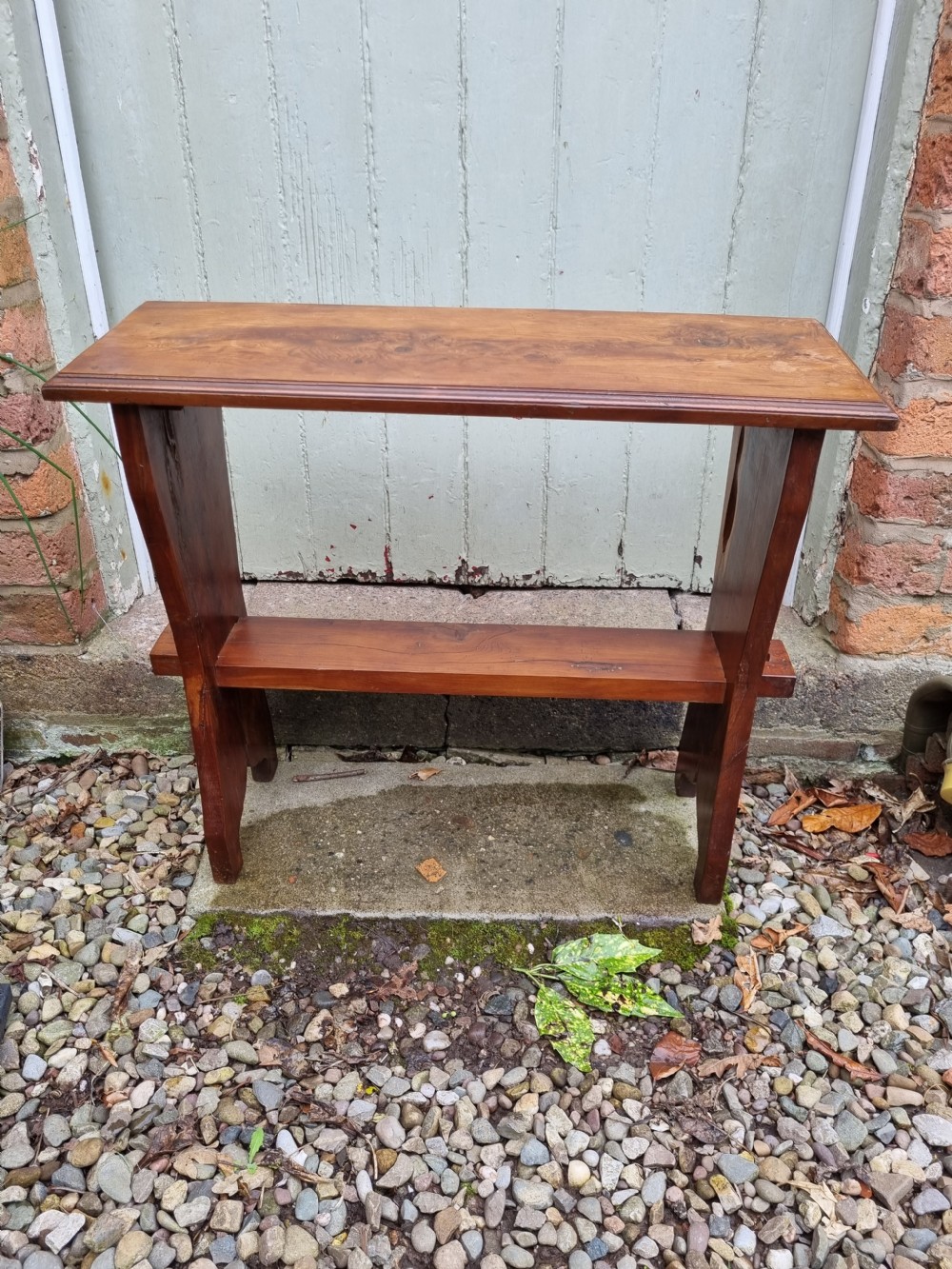 A rectangular solid yew wood stool with a lower shelf, moulded top edge, and slab-side legs. View V