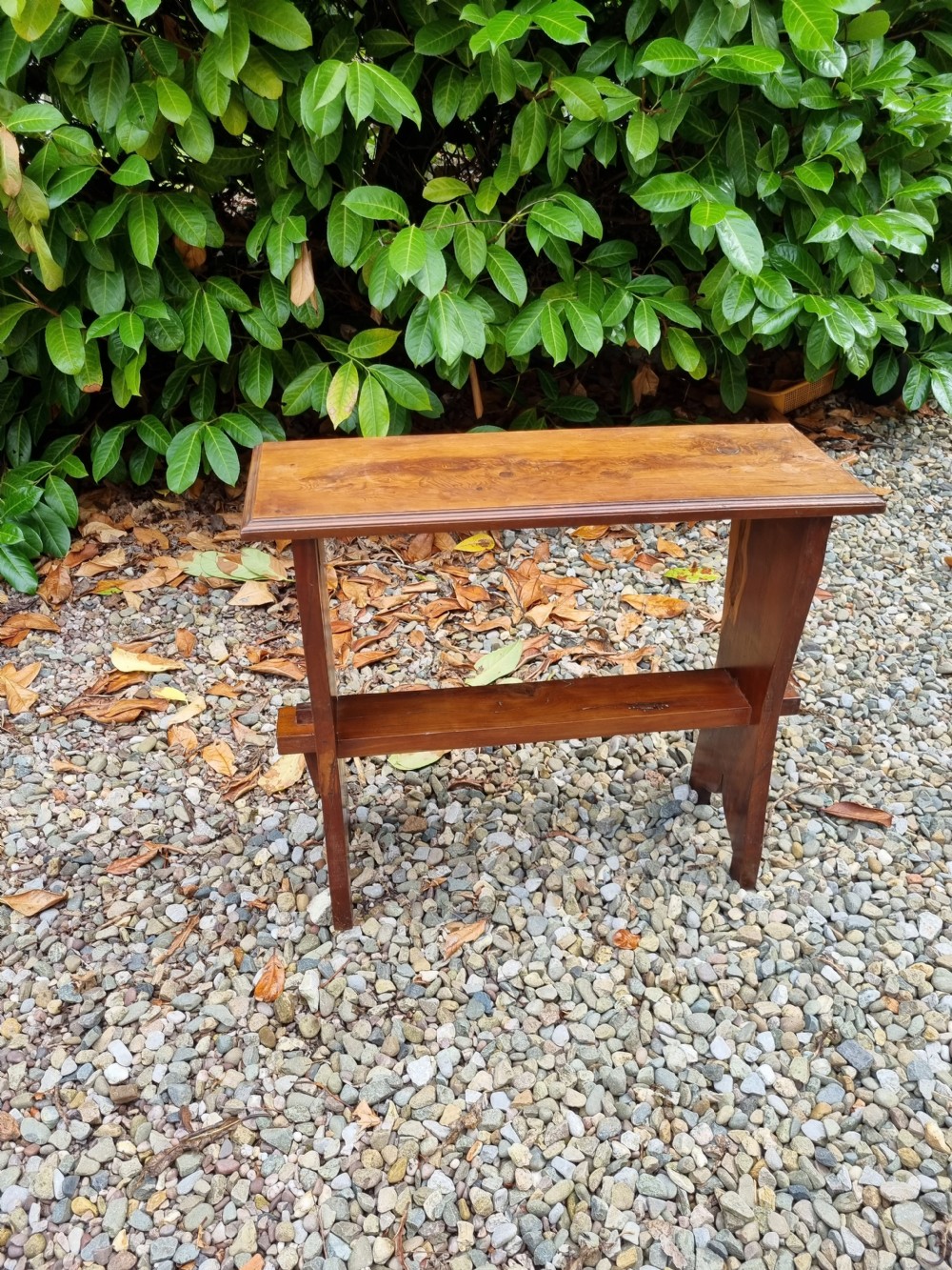 A rectangular solid yew wood stool with a lower shelf, moulded top edge, and slab-side legs. View VII