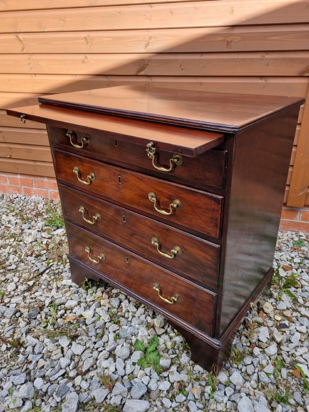 A SMALL 18THC MAHOGANY CHEST WITH A BRUSHING SLIDE 