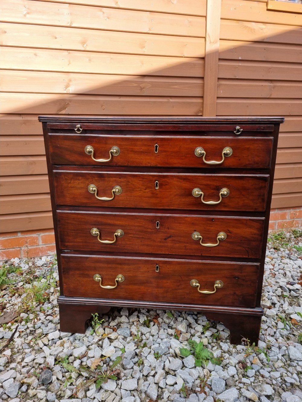 A SMALL 18THC MAHOGANY CHEST WITH A BRUSHING SLIDE  View III