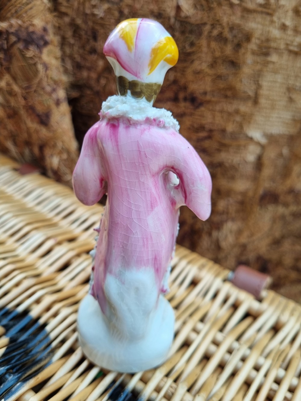 A 19th-century Staffordshire earthenware ceramic figurine depicting a figure wearing a turban, pink coat, and cobalt blue tunic with white textured trim. View III