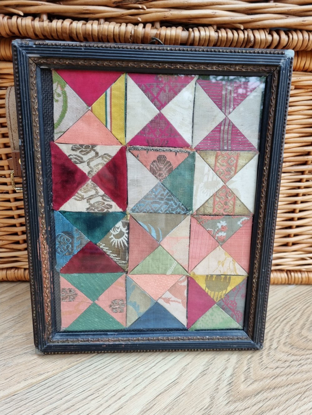 A RARE GEORGIAN FRAME OF SILKWORK MATERIAL SAMPLES C1770