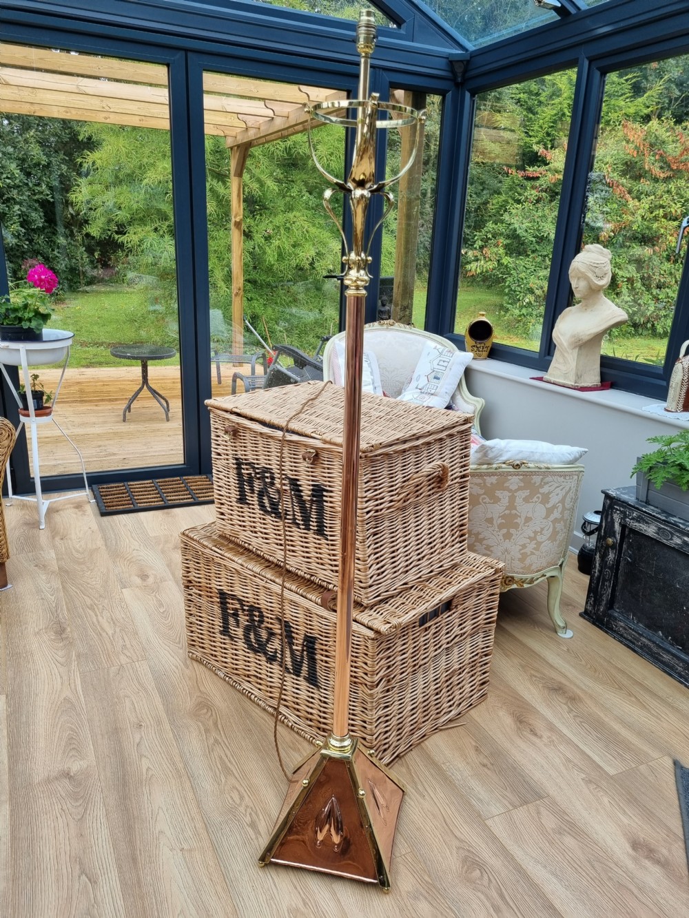 An Arts and Crafts style standard lamp crafted from copper and brass featuring a pyramidal base with decorative relief motifs and an extended central column. View IV