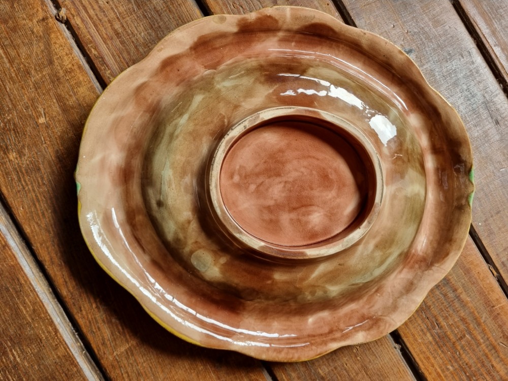 An oval Victorian majolica earthenware bread plate featuring a brown central field surrounded by moulded green and yellow wheat motifs. View III