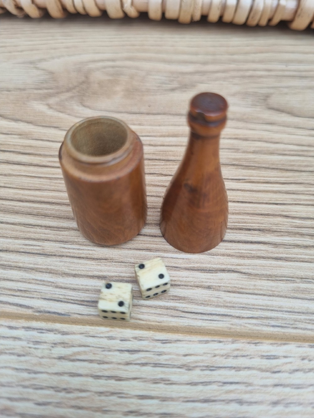 A TREEN DICE SHAKER IN THE FORM OF A WINE BOTTLE