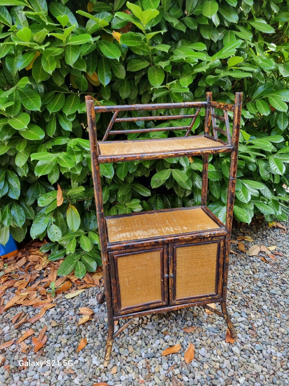 AN ARTS AND CRAFTS  BRITISH BAMBOO STAND WITH CUPBOARD