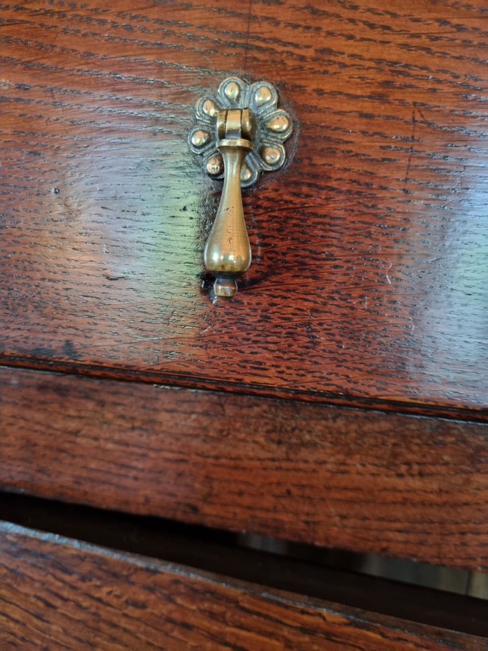 An 18th-century dark oak Welsh hanging cupboard featuring three upper drawers above double raised-panel doors. View IV