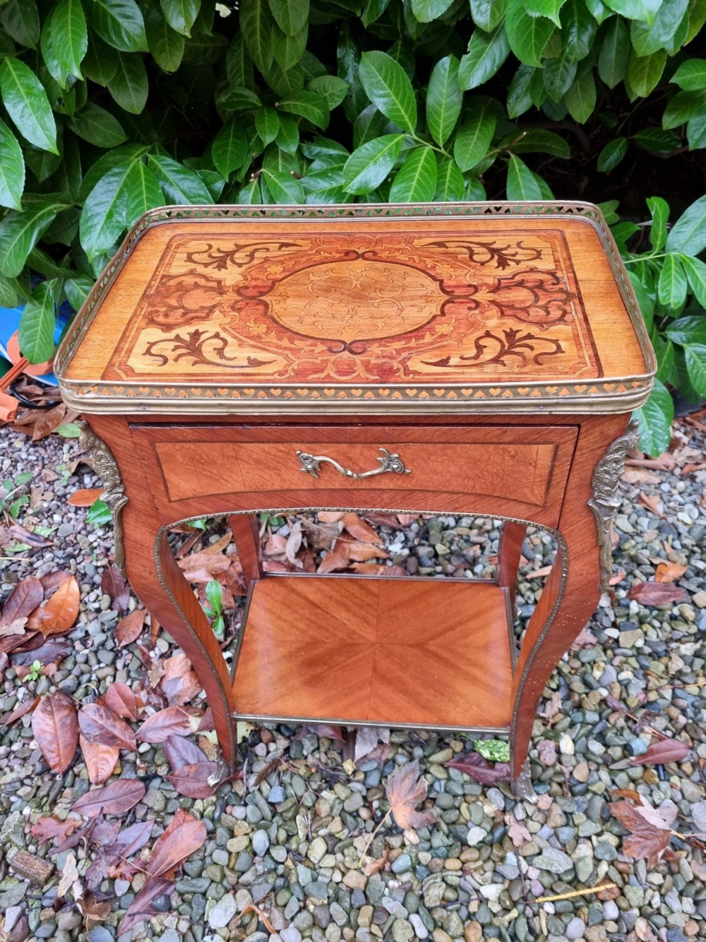 A 19th-century French kingwood side table featuring marquetry inlay, a single drawer, an under-shelf, cabriole legs, and a pierced brass top gallery. View VI