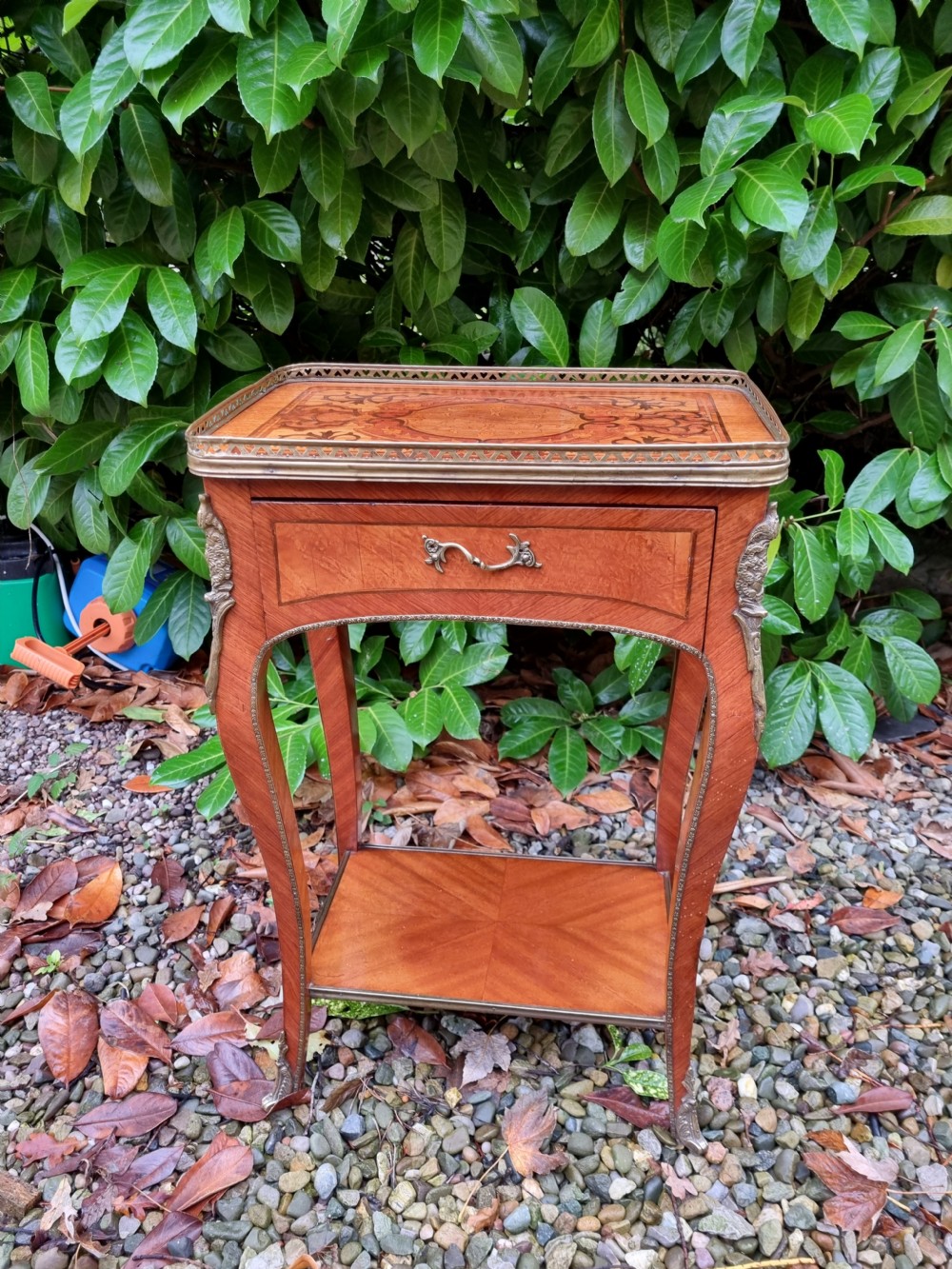 A 19th-century French kingwood side table featuring marquetry inlay, a single drawer, an under-shelf, cabriole legs, and a pierced brass top gallery. View VII