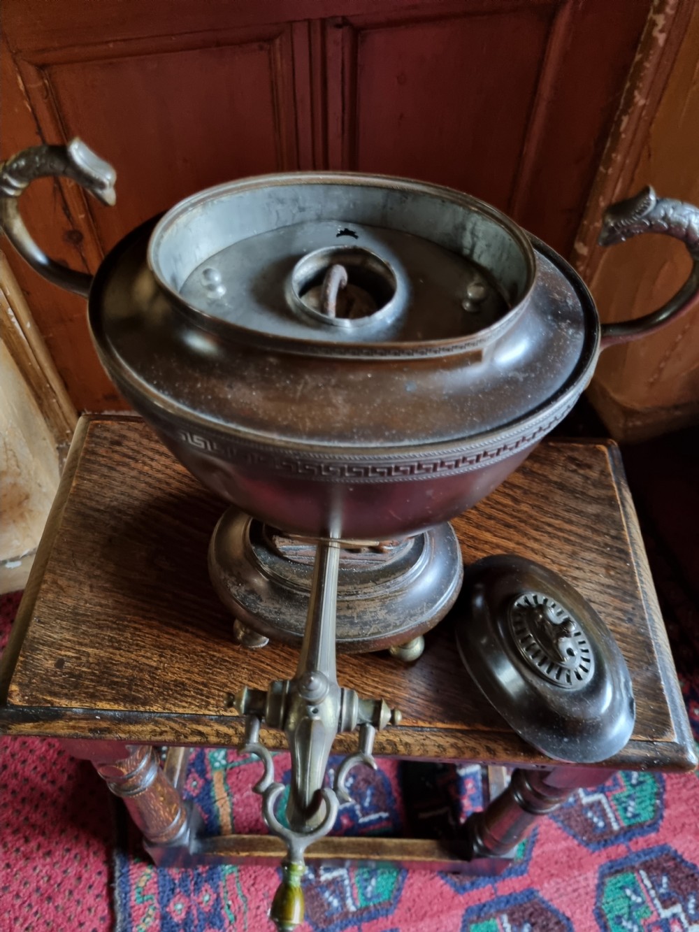 A dark patinated bronze and copper Regency tea samovar featuring a Greek key engraved border, side handles, spigoted tap, and pedestal base. View III