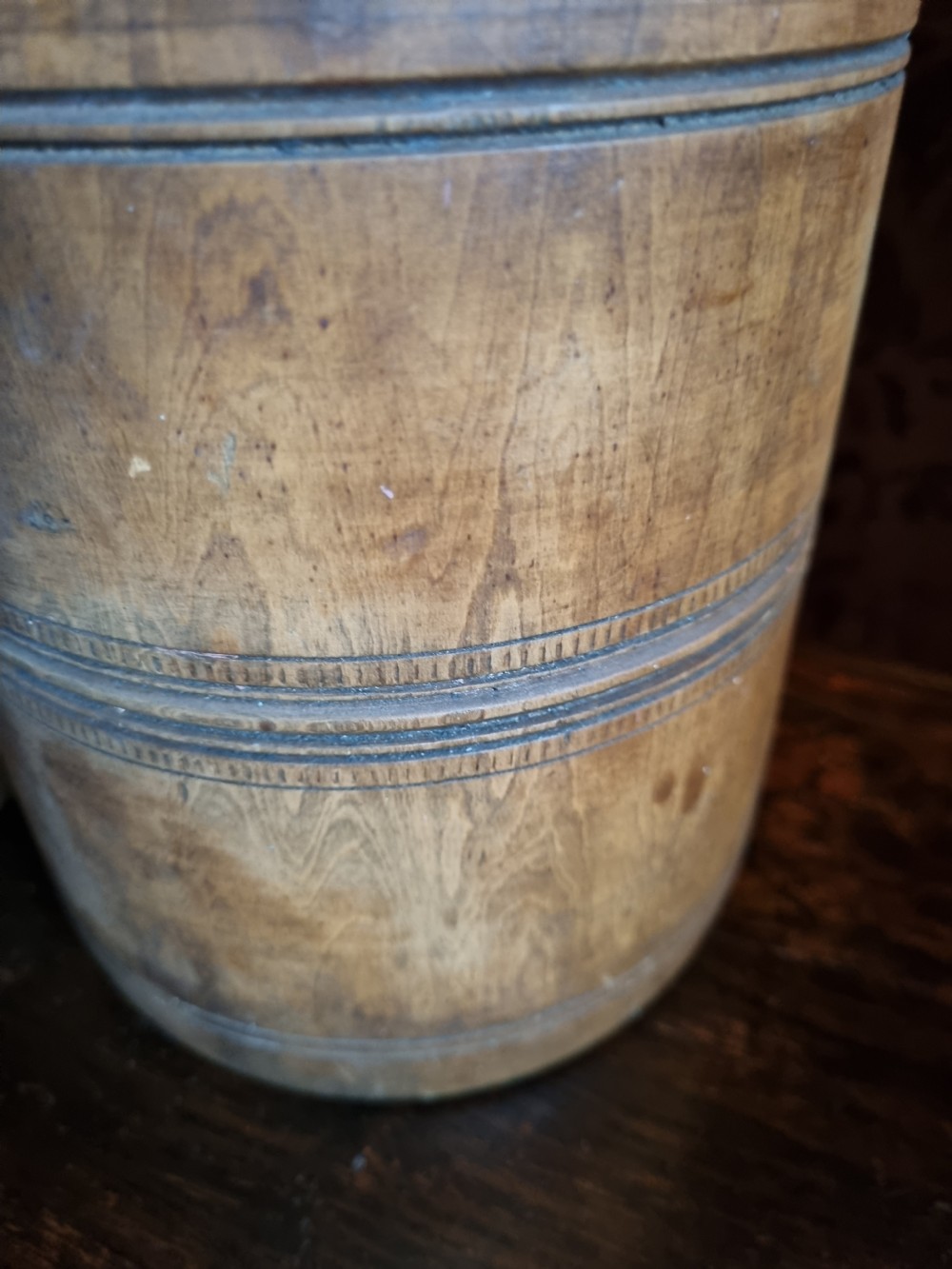 An 18th-century turned wooden mortar with a matching pestle showing hand-carved decorative outer rings. View III