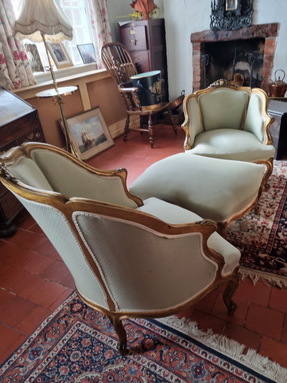 A 19th-century three-piece French duchesse brisee seating set featuring carved giltwood frames and sage green upholstery. View VI