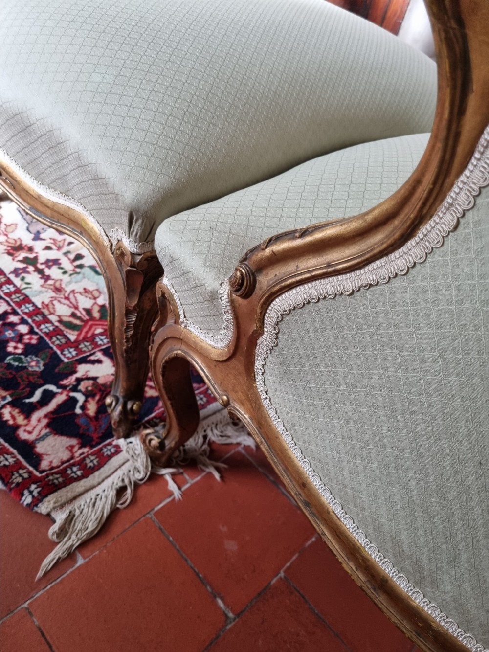 A 19th-century three-piece French duchesse brisee seating set featuring carved giltwood frames and sage green upholstery. View VII