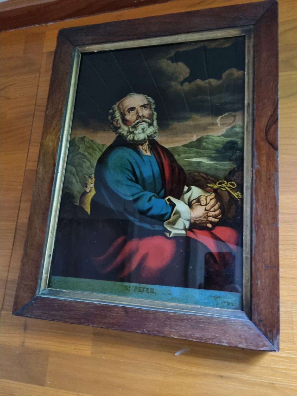 A late eighteenth to early nineteenth-century reverse glass picture depicting Saint Peter with clasped hands inside a moulded wooden frame. View IV