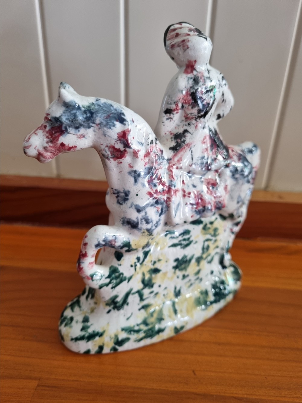 A 19th-century Scottish Portobello earthenware figure depicting a lady seated side-saddle on a horse with hand-sponged polychrome decoration on a cream glaze. View II