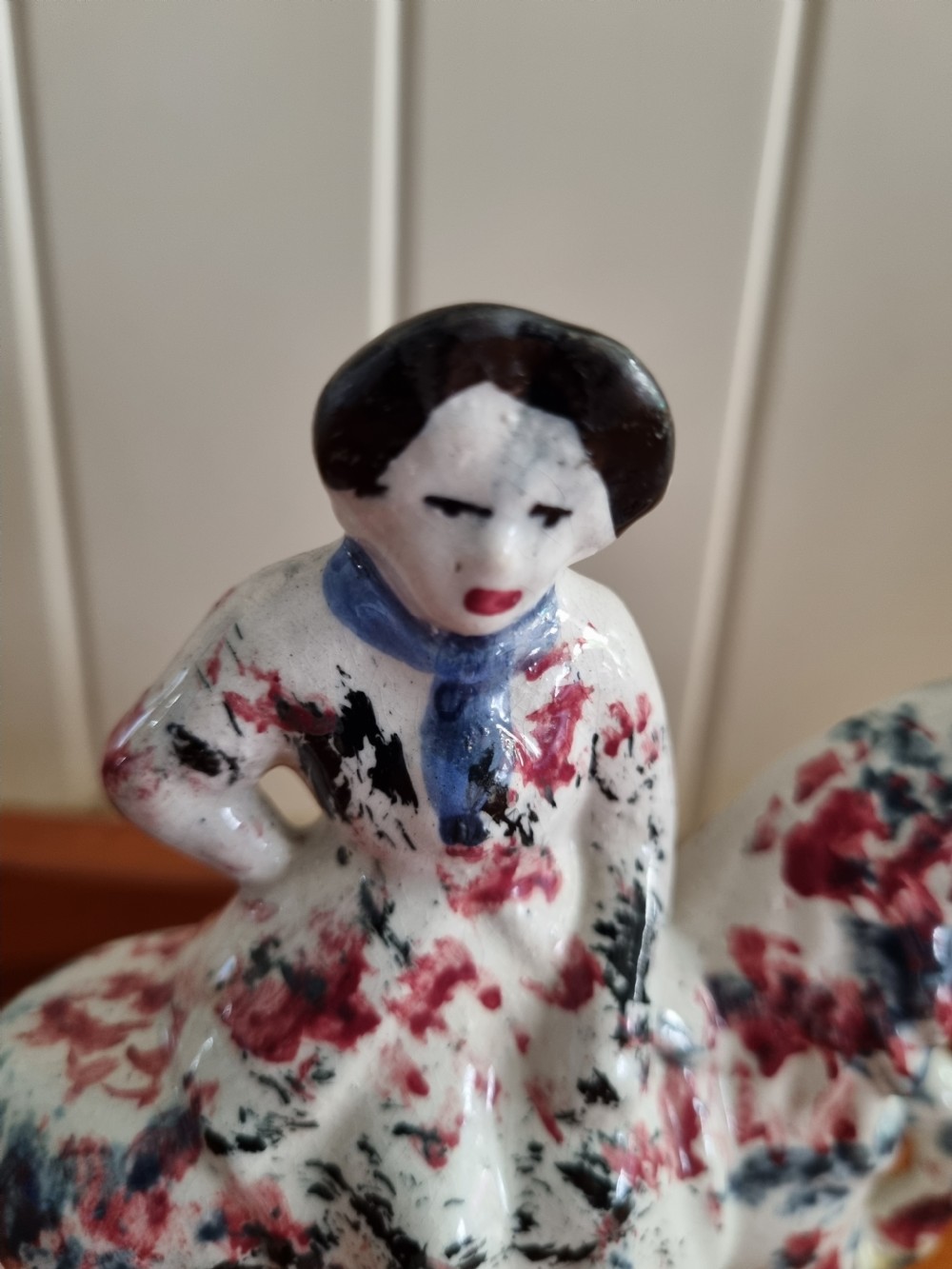 A 19th-century Scottish Portobello earthenware figure depicting a lady seated side-saddle on a horse with hand-sponged polychrome decoration on a cream glaze. View V