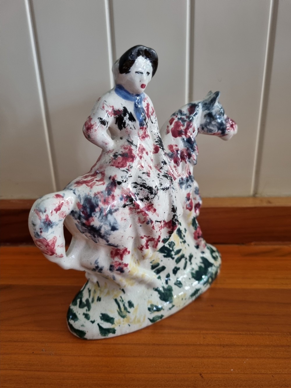 A 19th-century Scottish Portobello earthenware figure depicting a lady seated side-saddle on a horse with hand-sponged polychrome decoration on a cream glaze. View VII