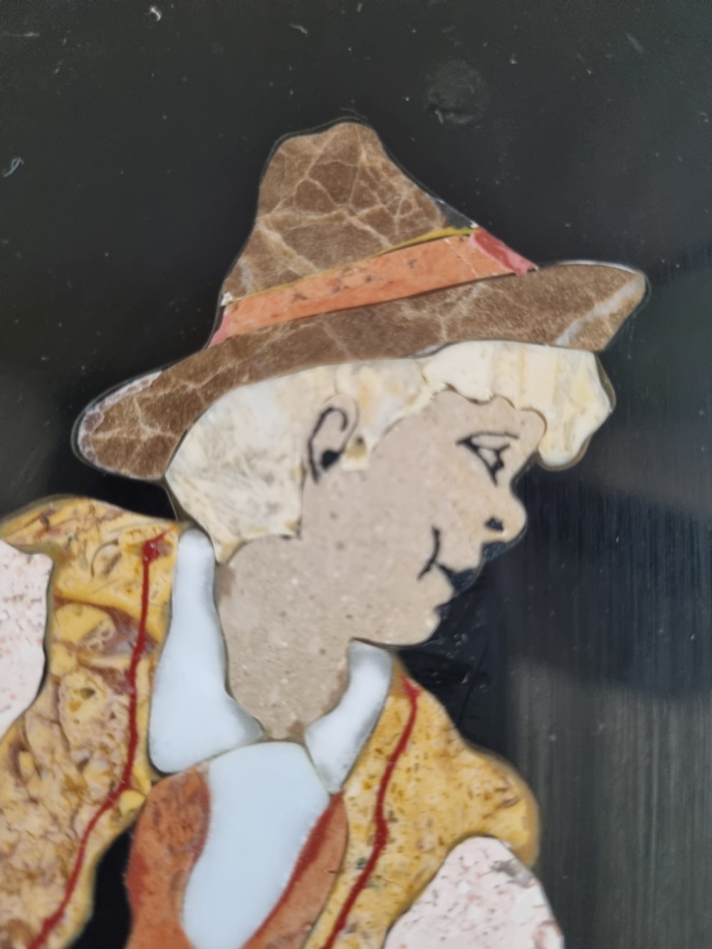 A 19th-century Italian pietre dure mosaic plaque depicting a shepherd boy in traditional dress within a moulded gilt frame. View V