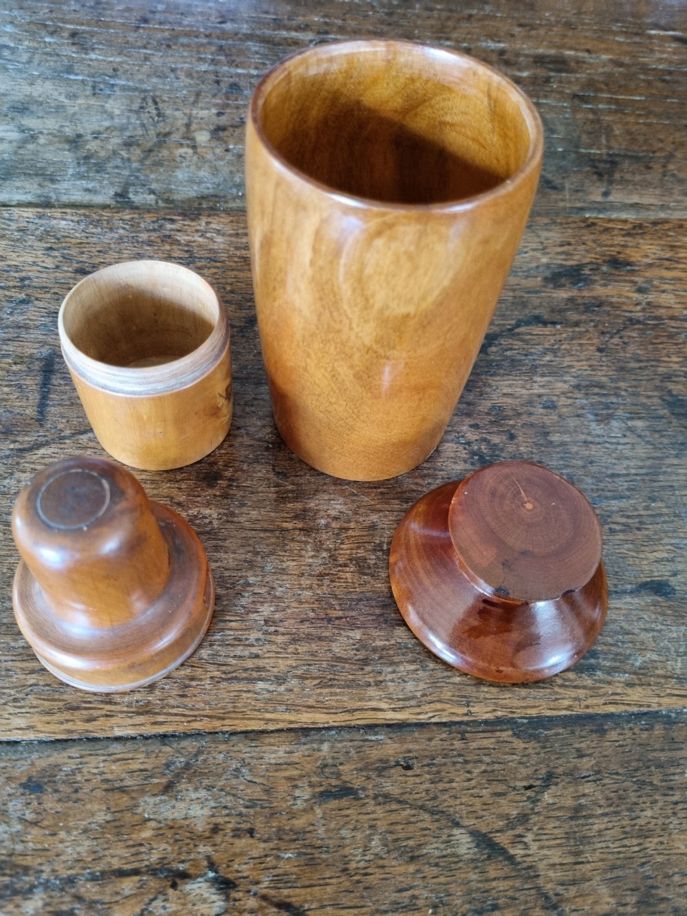 A pair of 19th-century turned sycamore wood jars with fitted covers, displaying a warm honey-brown finish and subtle grain patterns. View III