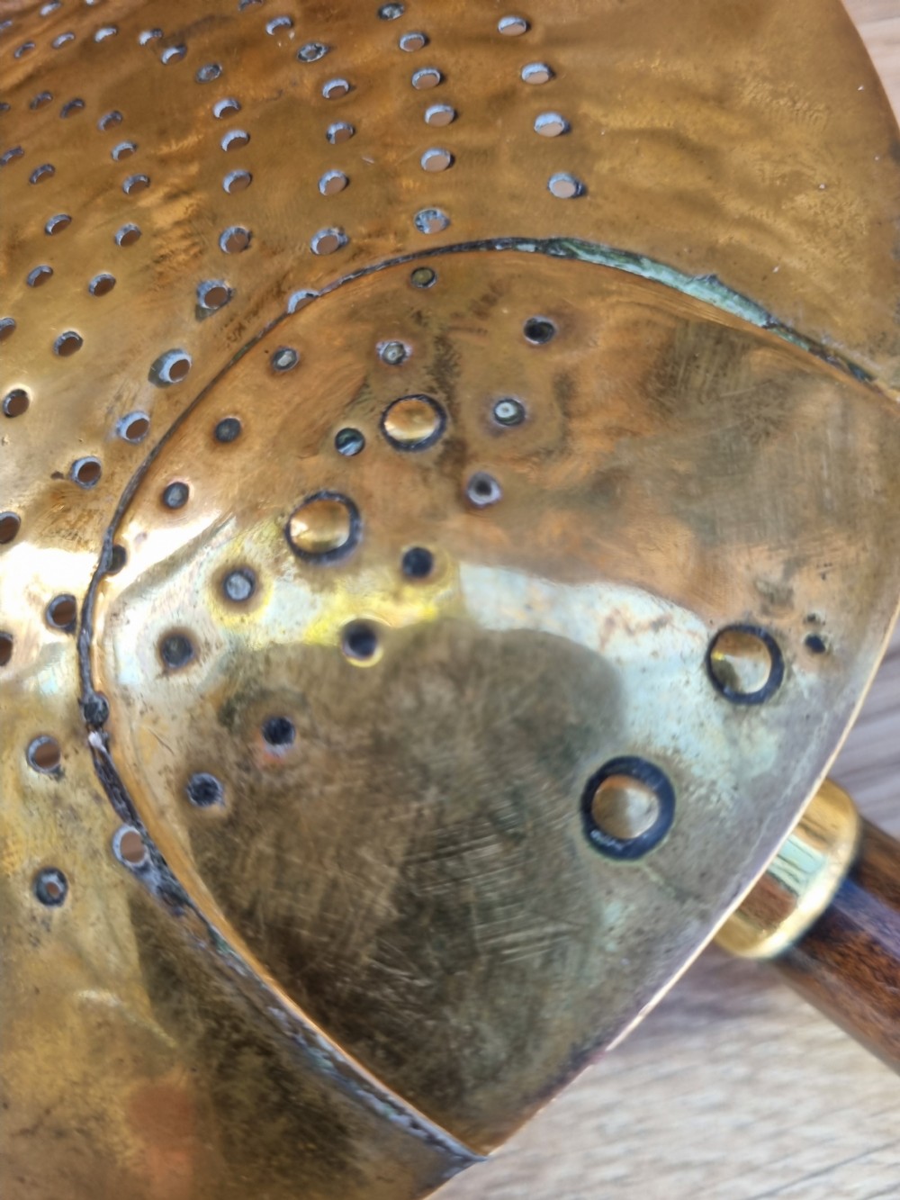 AN UNUSUAL 18THC BRASS HAND HELD MILK SKIMMER  View III