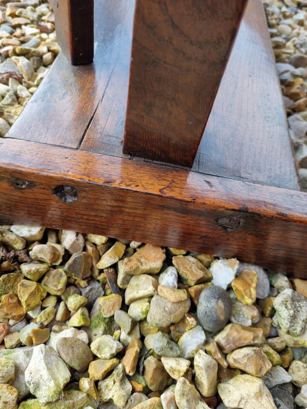 An eighteenth-century dark oak gateleg table featuring drop-down oval leaves, turned column supports, and a flat sleigh base. View III