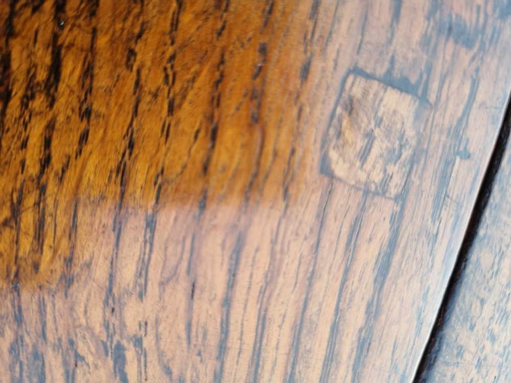An eighteenth-century dark oak gateleg table featuring drop-down oval leaves, turned column supports, and a flat sleigh base. View VII