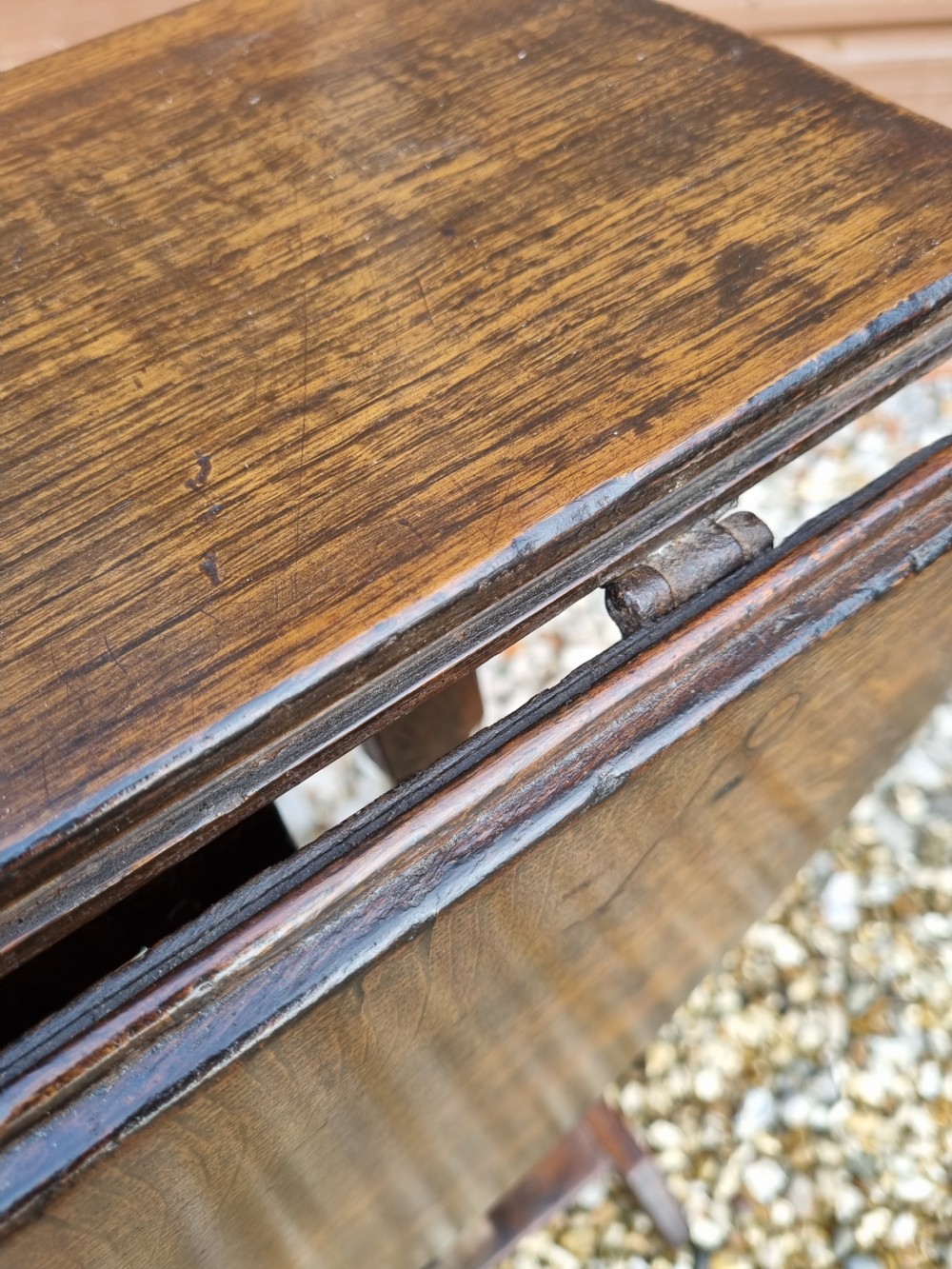 An eighteenth-century dark oak gateleg table featuring drop-down oval leaves, turned column supports, and a flat sleigh base. View VIII