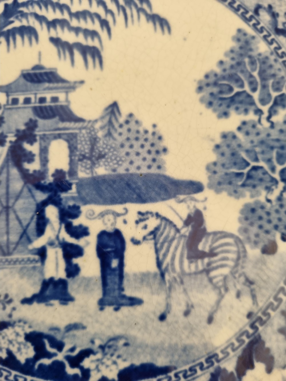 A set of four 19th-century blue and white transferware ceramic plates featuring detailed pictorial landscape scenes and floral borders. View VI