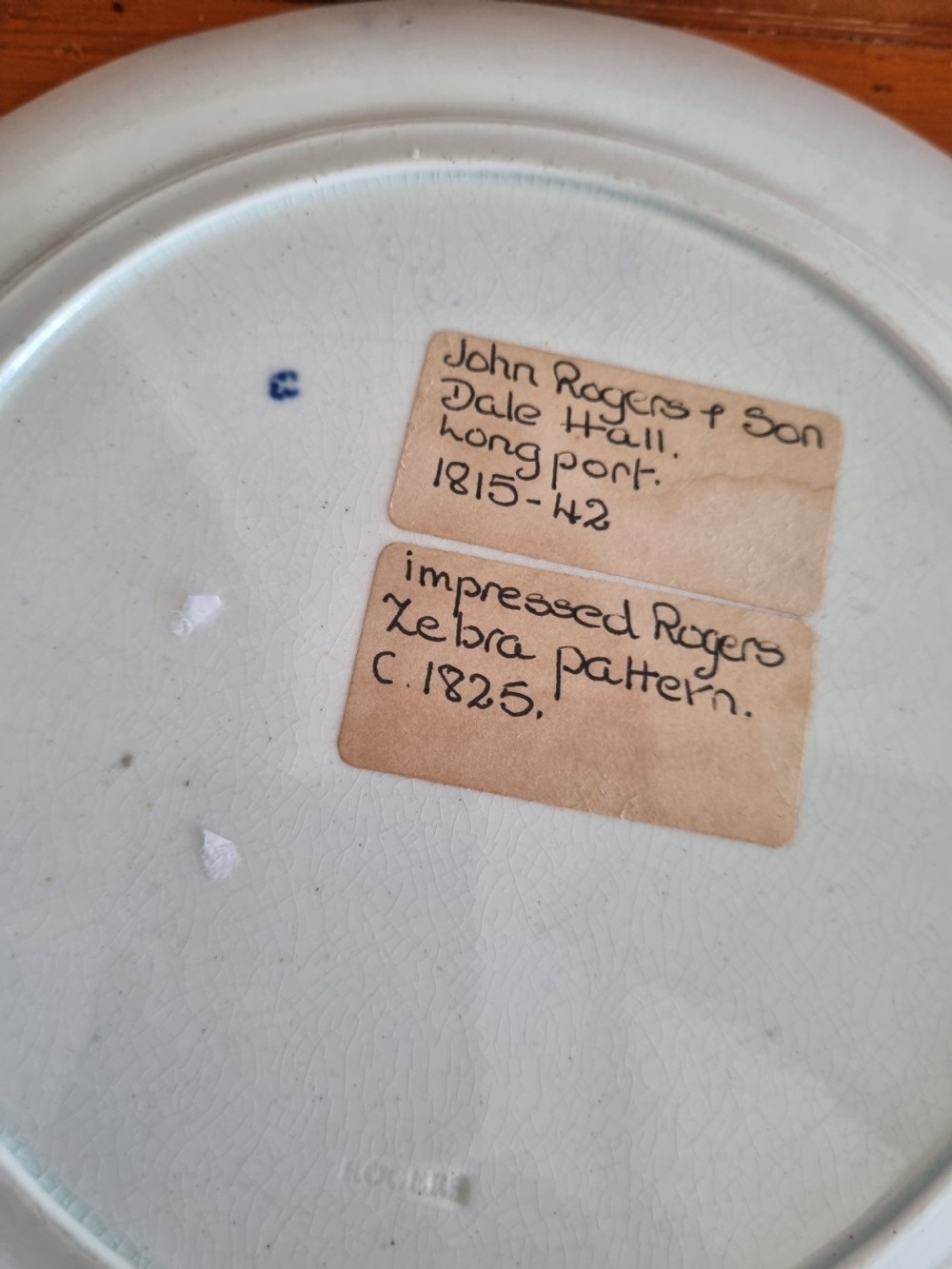 A set of four 19th-century blue and white transferware ceramic plates featuring detailed pictorial landscape scenes and floral borders. View VII