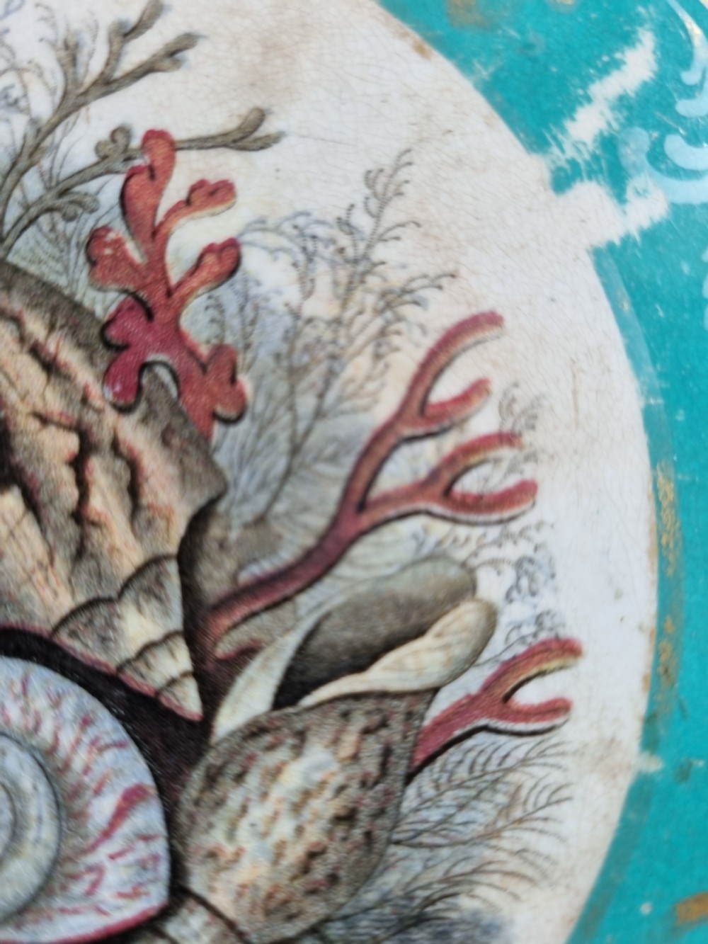 A pair of square Victorian Prattware ceramic teapot stands, one featuring a turquoise border with a marine shell medallion and the other featuring an ornate border with an equestrian scene. View V