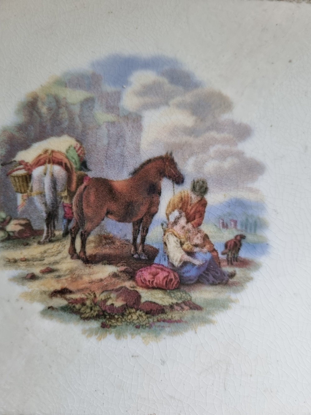 A pair of square Victorian Prattware ceramic teapot stands, one featuring a turquoise border with a marine shell medallion and the other featuring an ornate border with an equestrian scene. View VI