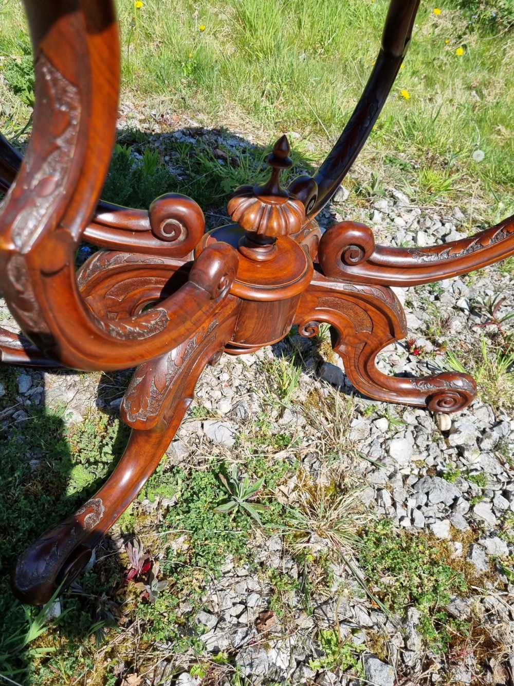 An antique Victorian burr walnut centre table with a scalloped serpentine top, wood inlay detail, and a carved four-legged base. View II