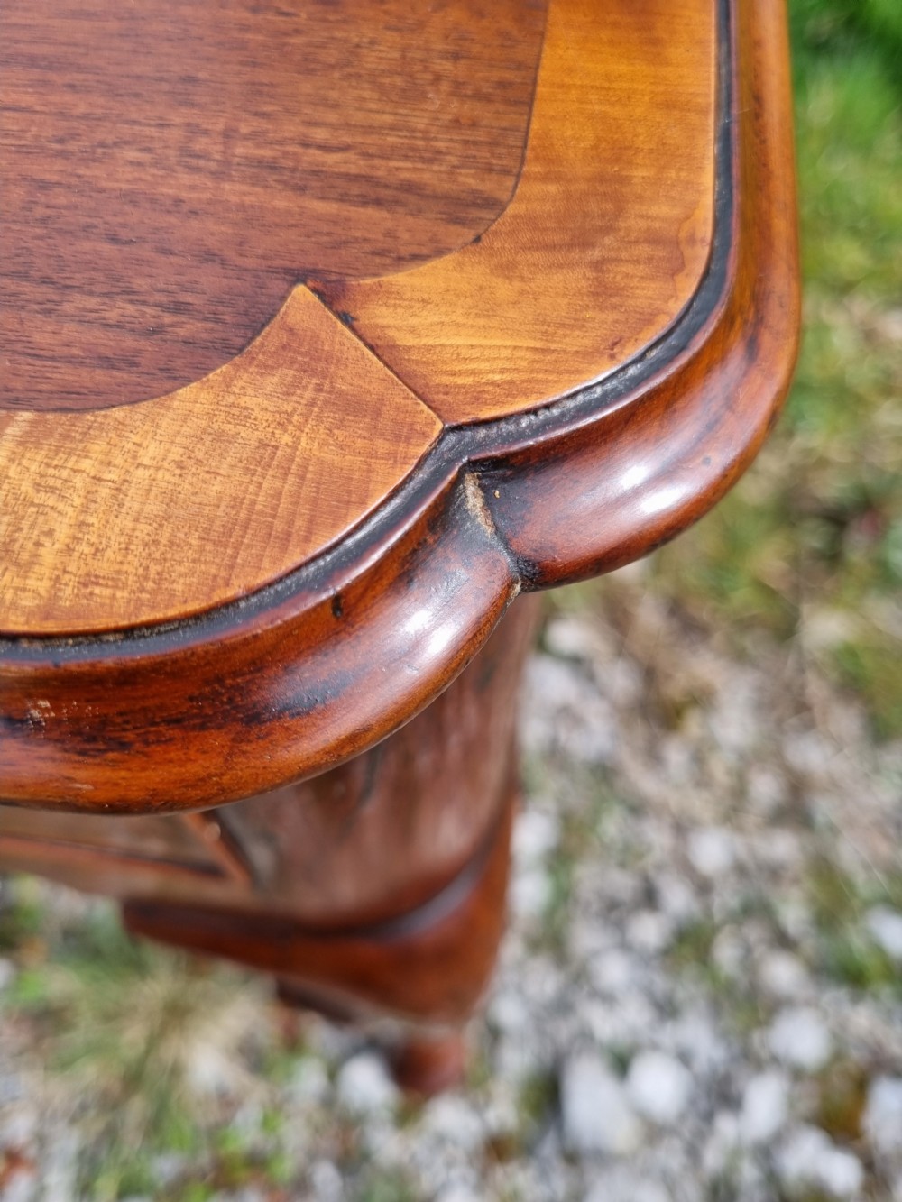 An Early Georgian walnut lowboy table featuring a single drawer with brass handles, crossbanded top border, and cabriole legs with pad feet. View II