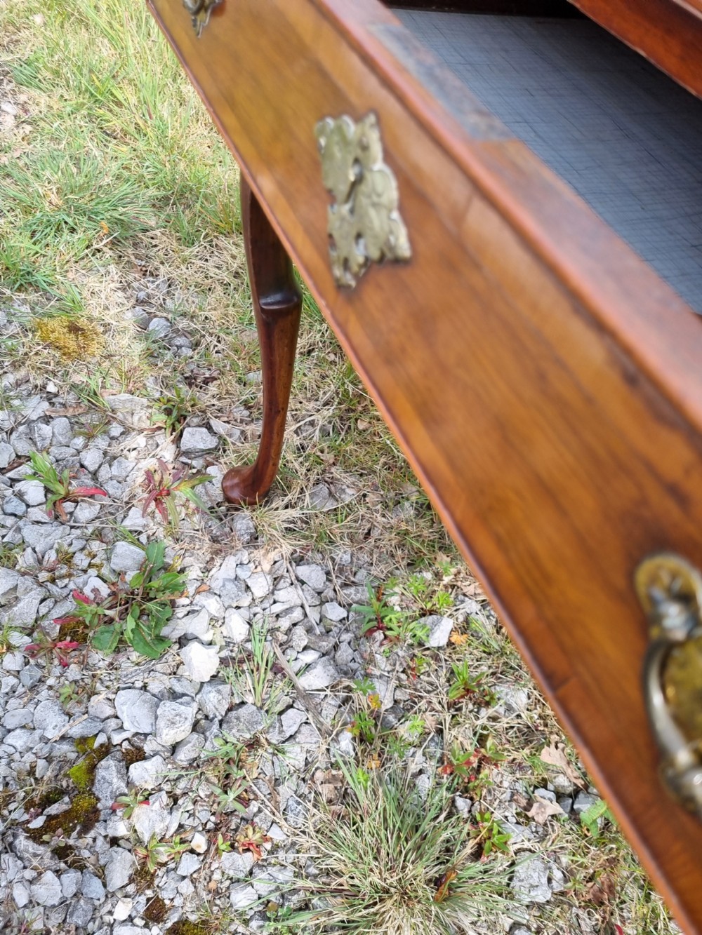 An Early Georgian walnut lowboy table featuring a single drawer with brass handles, crossbanded top border, and cabriole legs with pad feet. View VII