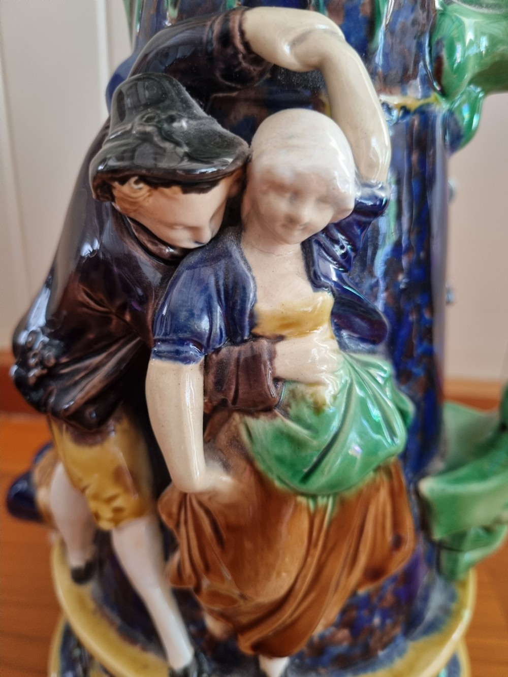 A Victorian Minton majolica ceramic jug decorated with high-relief figures of dancing couples in polychrome glazes against a dark blue background. View VII