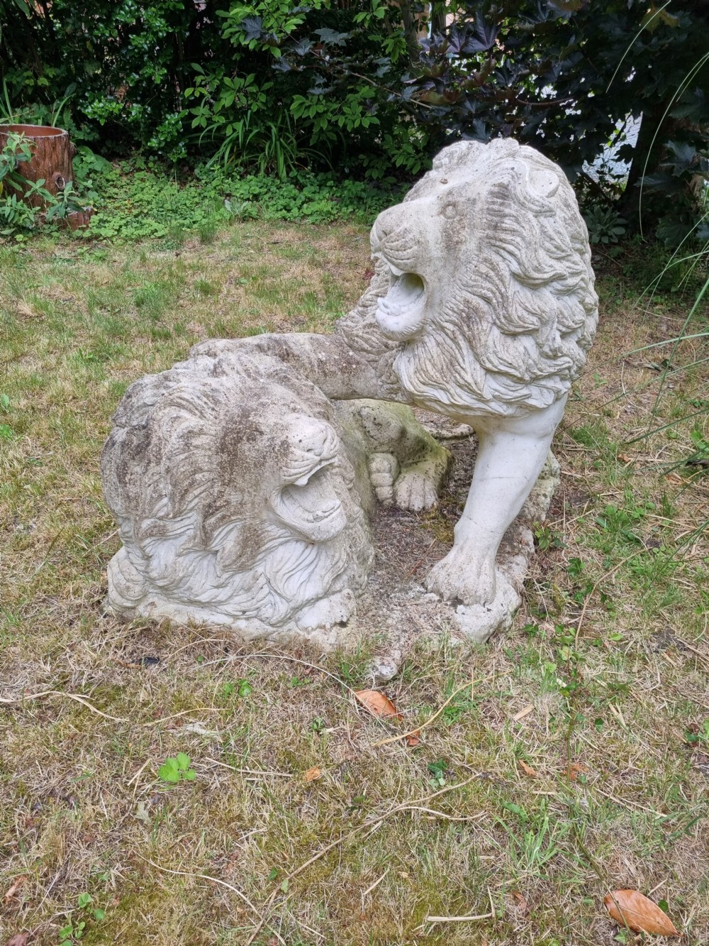 A weathered 19th-century Italian carved marble garden sculpture depicting roaring lions. View IV
