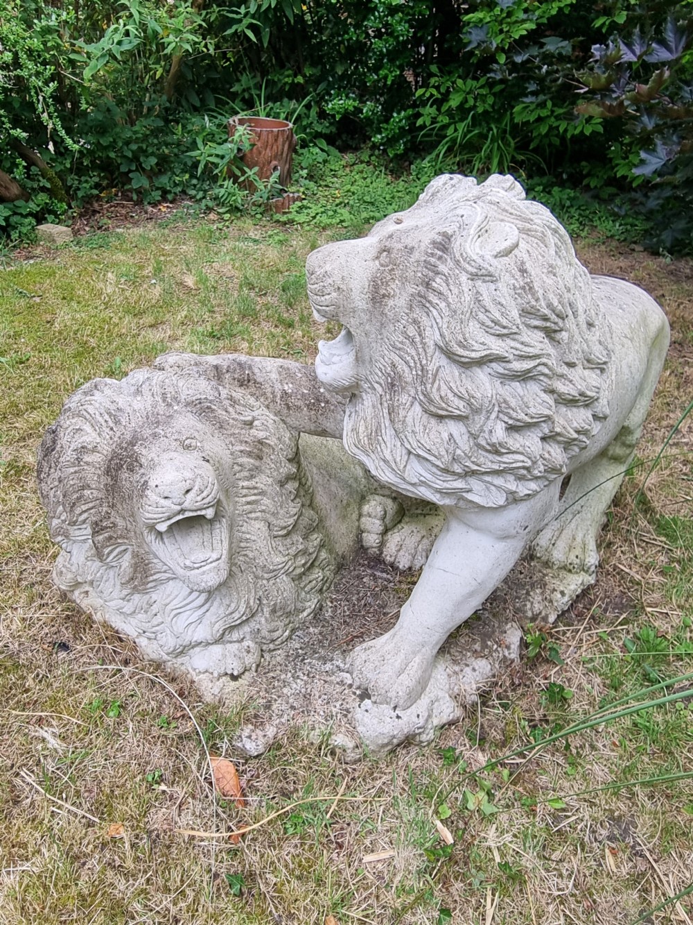 A weathered 19th-century Italian carved marble garden sculpture depicting roaring lions. View VI