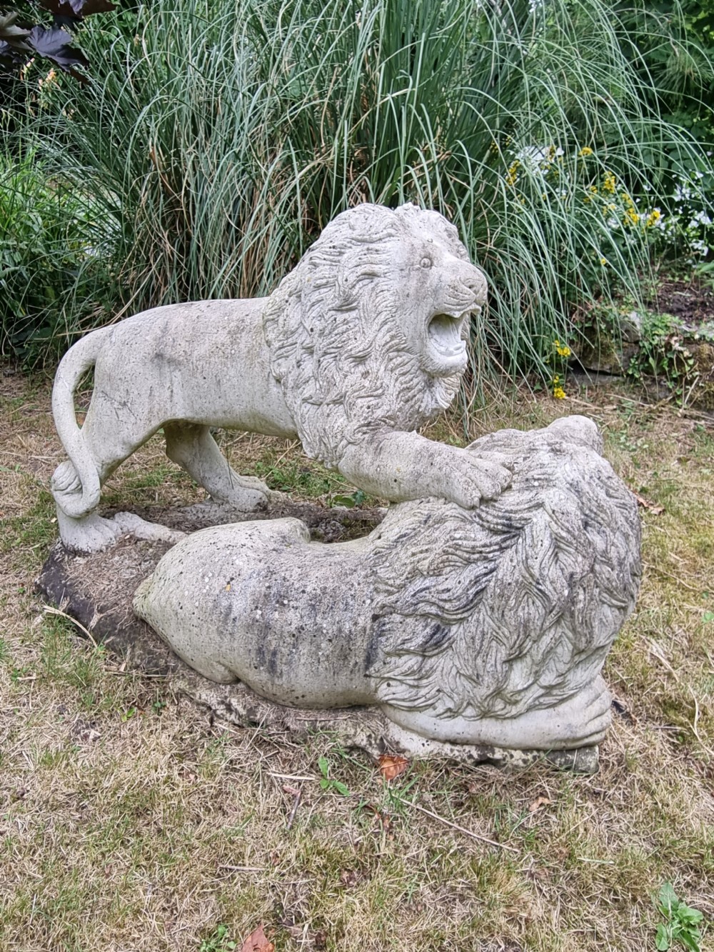 A weathered 19th-century Italian carved marble garden sculpture depicting roaring lions. View III