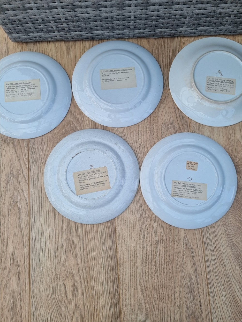 A set of five circular Victorian Prattware ceramic plates featuring polychrome transfer-printed pastoral landscape scenes with decorative gold geometric borders. View VIII