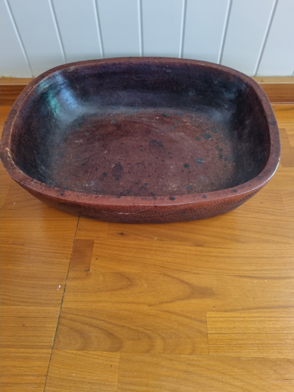 An oval 19th-century reddish-brown stoneware cooking dish featuring incised leaf patterns carved along the exterior side. View VII