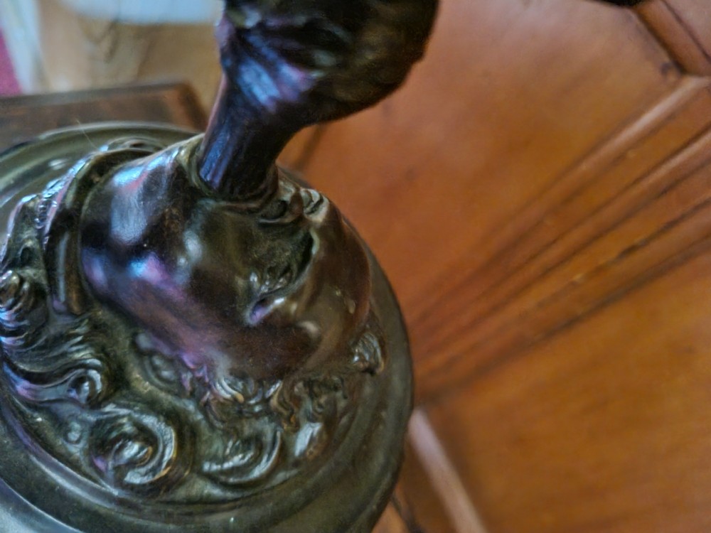 A dark patinated bronze figure depicting the allegorical figure of Fortuna mounted atop a cylindrical plinth. View III
