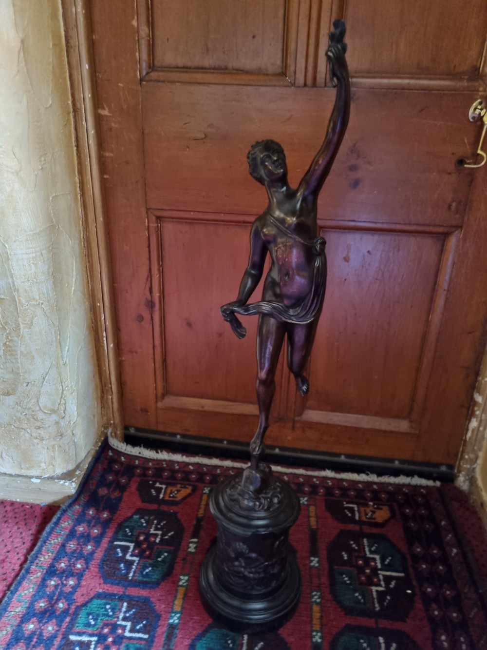 A dark patinated bronze figure depicting the allegorical figure of Fortuna mounted atop a cylindrical plinth. View VI