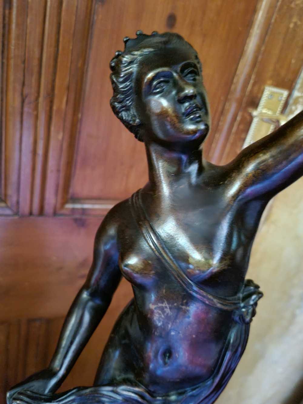 A dark patinated bronze figure depicting the allegorical figure of Fortuna mounted atop a cylindrical plinth. View VII