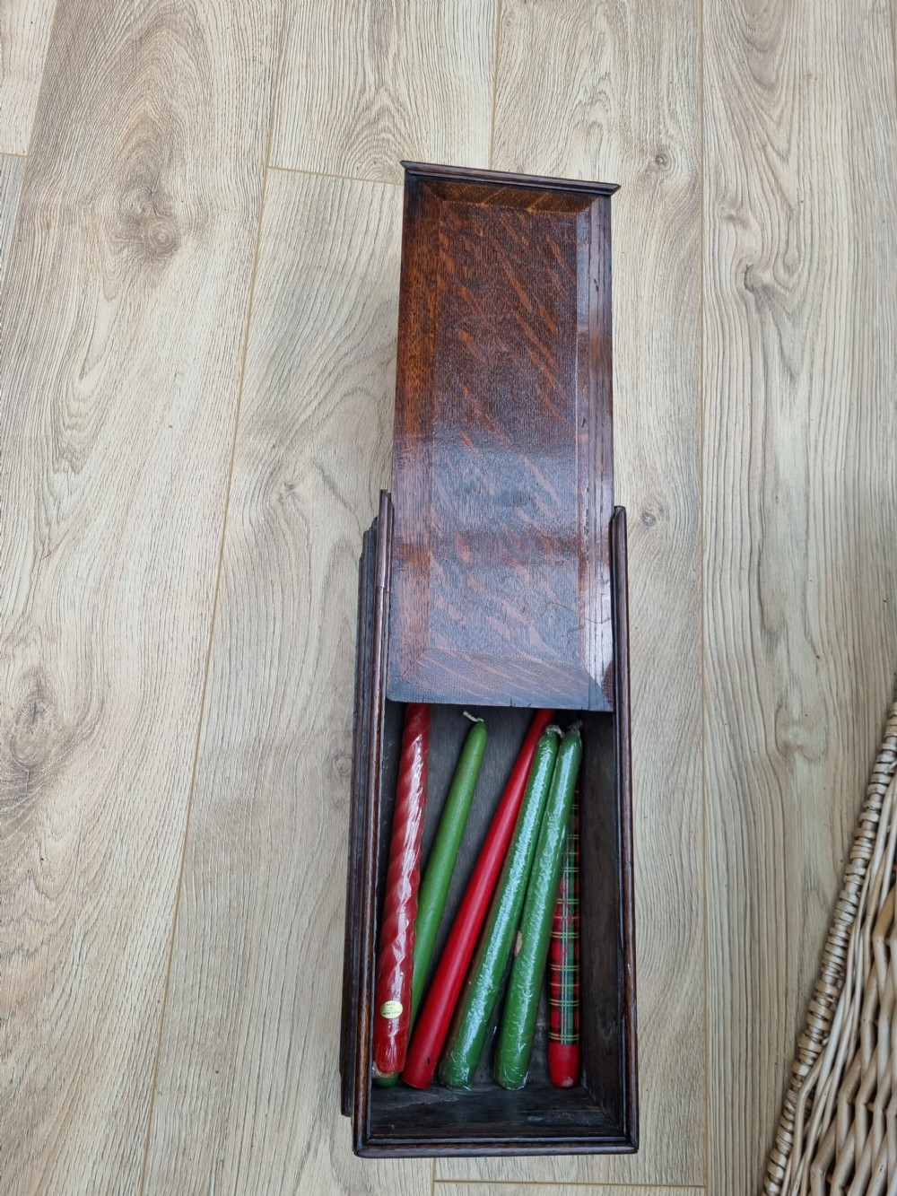 An antique dark oak hanging candle box featuring a shaped backboard with a wall-mounting aperture and a sliding front panel. View VI
