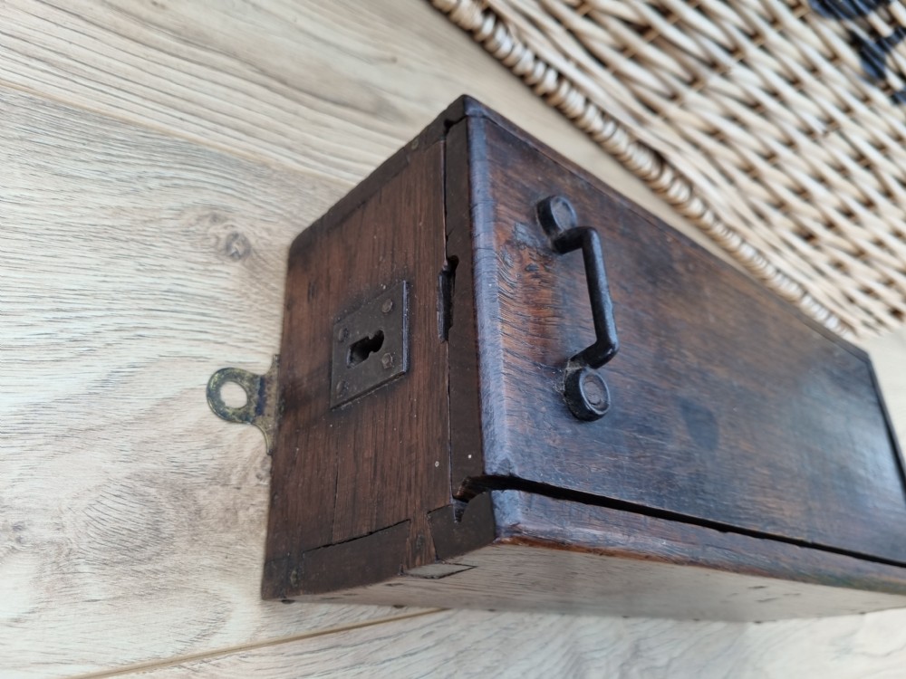 A rectangular dark oak primitive hanging candle box featuring a sliding lid with an iron handle. View II