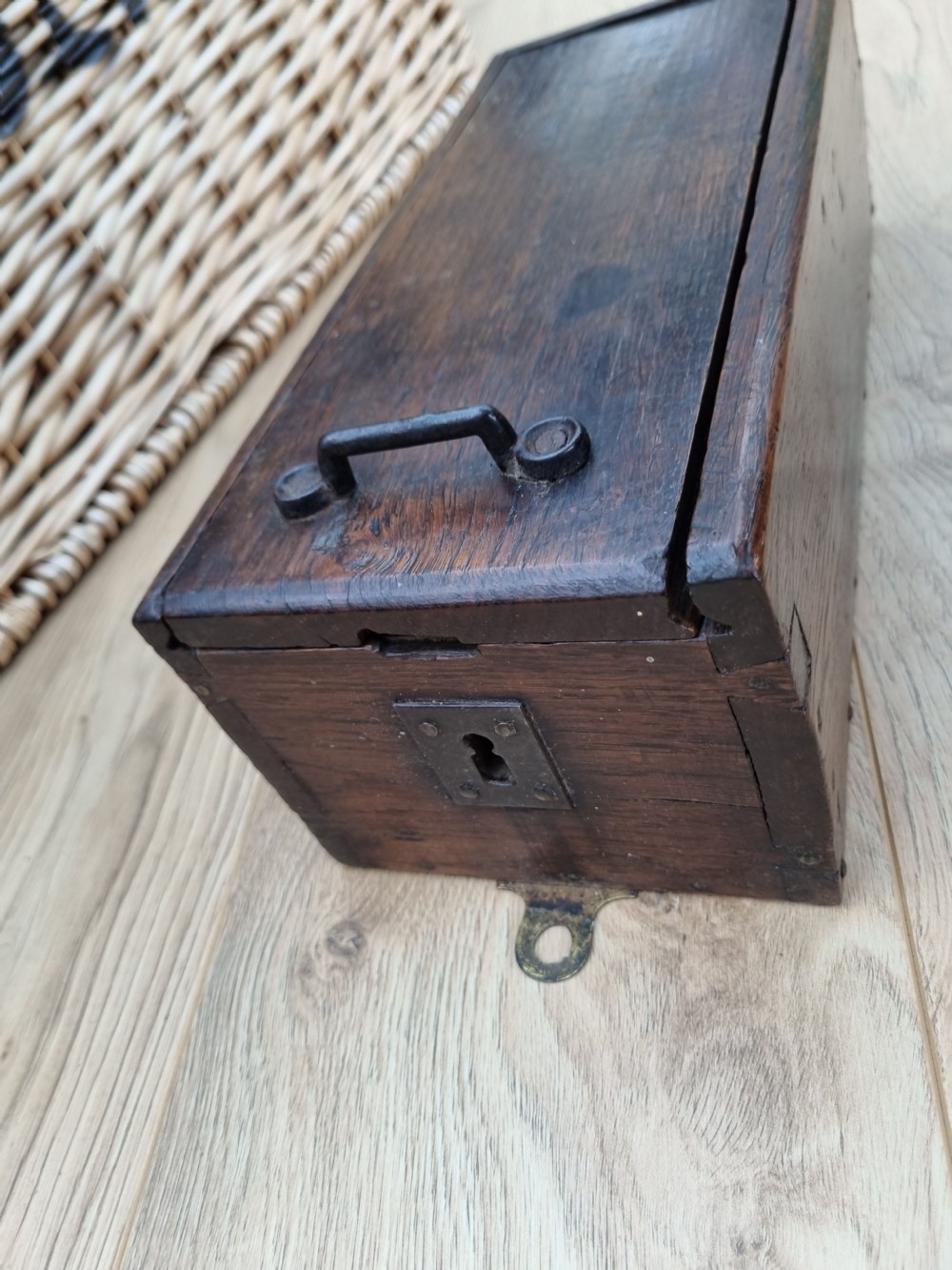 A rectangular dark oak primitive hanging candle box featuring a sliding lid with an iron handle. View V