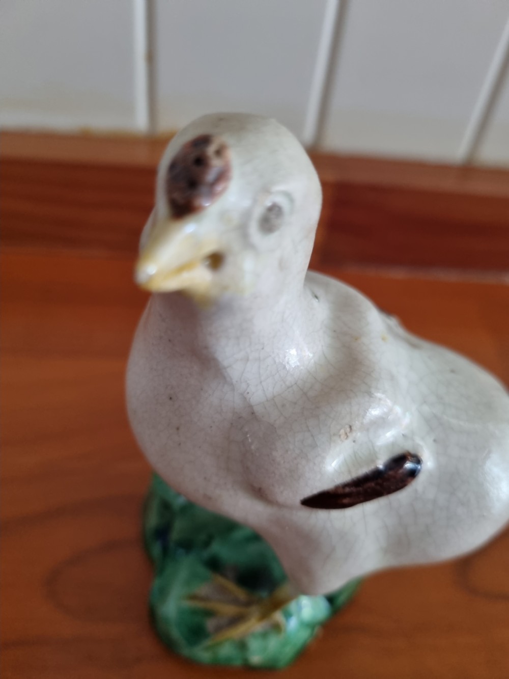 A late 18th-century Prattware glazed ceramic figure of a chicken standing on a textured green base. View VII